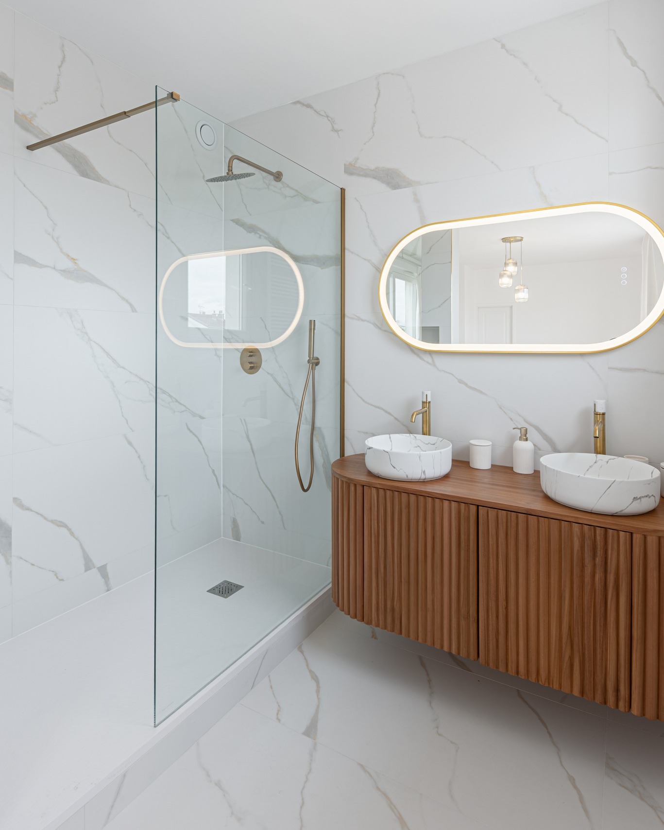 Quand le marbre, le bois et l’or brossé se rencontrent, la salle de bain devient une vraie pièce de caractère 🎊  Le marbre blanc apporte de la lumière, tandis que le meuble en bois réchauffe l’ensemble avec une touche très contemporaine 🤍  Au centre de cette composition, nos mitigeurs de lavabo Manopola en or brossé viennent capter la lumière et sublimer les vasques effet marbre ✨  On aime aussi le rappel du doré dans la robinetterie de douche et le miroir rétroéclairé qui agrandit visuellement l’espace ! ☀️  Un équilibre parfait entre matières naturelles, lignes douces et finitions élégantes pour une salle de bain aussi design qu’apaisante 🥰  Merci à at:originatelier de nous avoir identifiés sur sa superbe réalisation 🙏   #democratikdesign #essebagno #mitigeur #salledebain #bathroomdesign #bathroomdecor #decointerieur #renovationmaison #homedecor